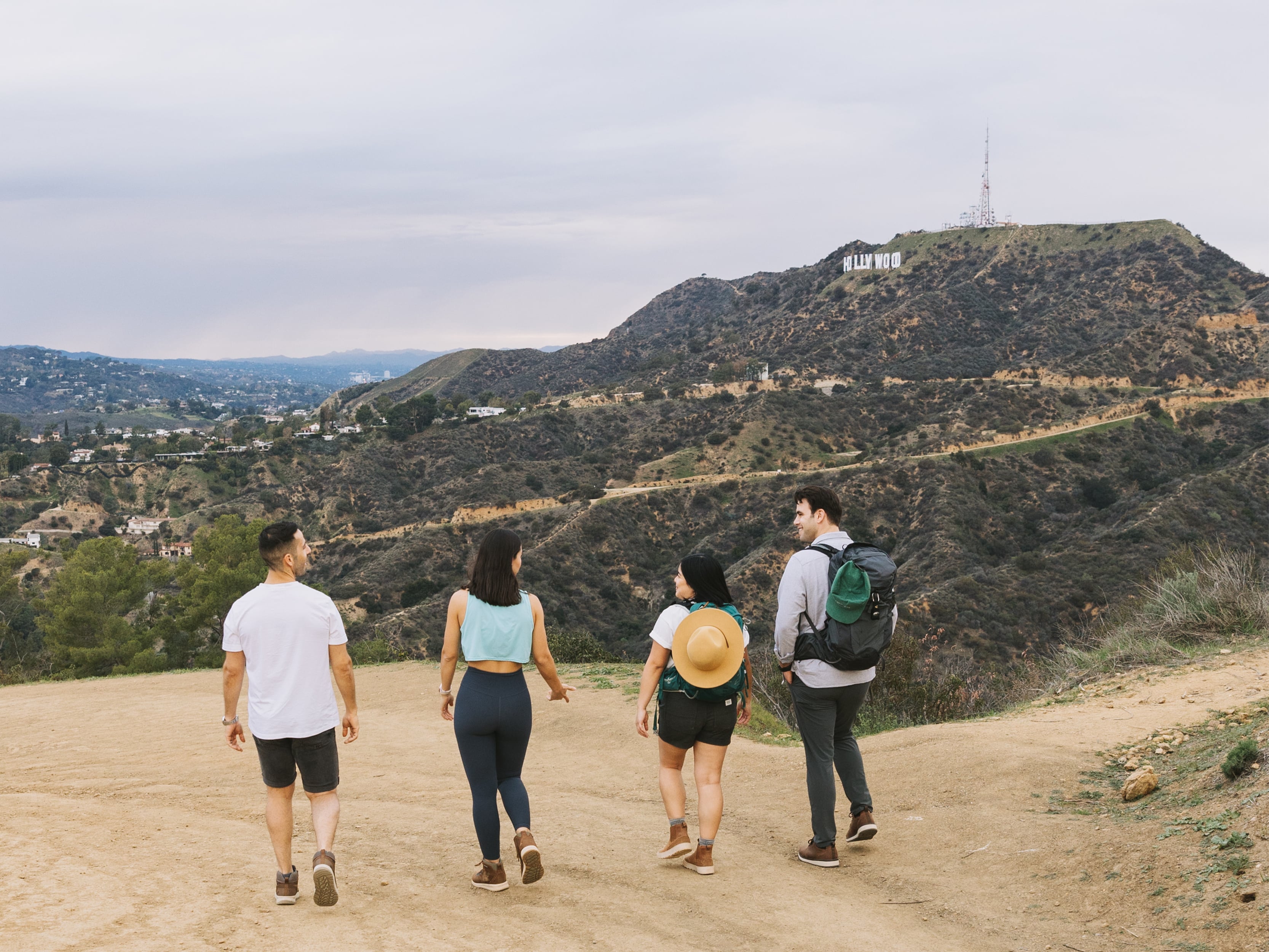 The featured image is four adults walking on a trail wearing Forsake shoes.