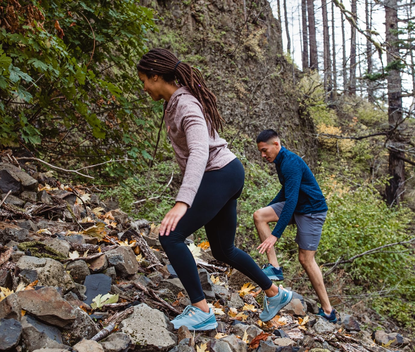 Click to shop the men's and women's Cascade Trail. Image features a man and women hiking in their Cascade Trails.