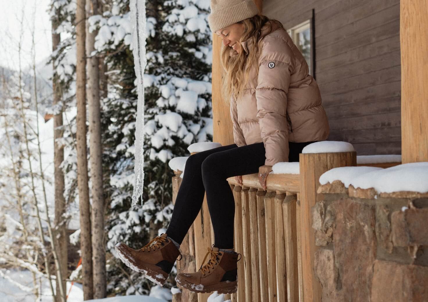 Shop All Forsake Women's Shoes featuring a woman wearing the Isla High Waterproof Outdoor Boot in Toffee on a snowy patio.